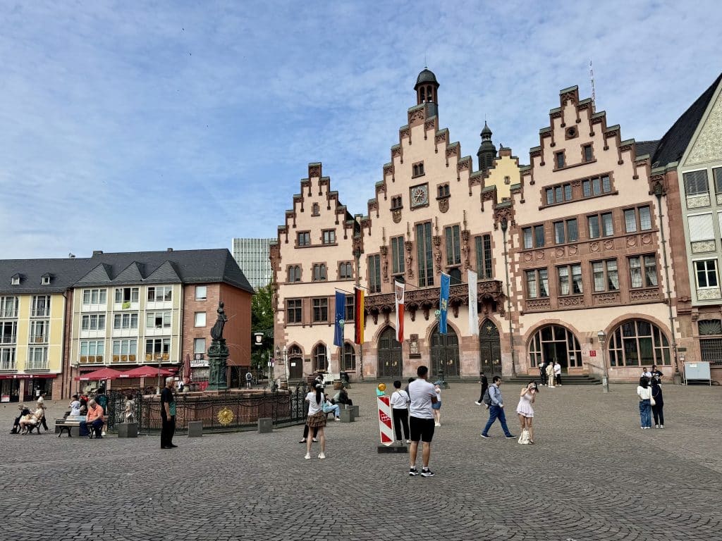 Frankfurt's main square in the new old town, with pointy peach-colored buildings with lots of windows.