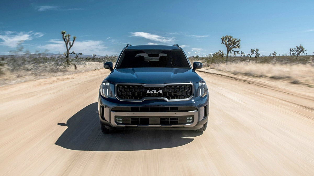 A blue Kia