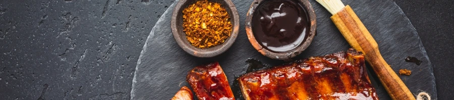 A top view of smoked ribs and seasonings