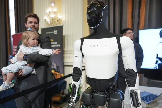 A Tesla robot is displayed as U.S. robotics companies look for congressional support to compete with Chinese companies, on Capitol Hill in Washington, Wednesday, March 26, 2025. (AP Photo/J. Scott Applewhite)