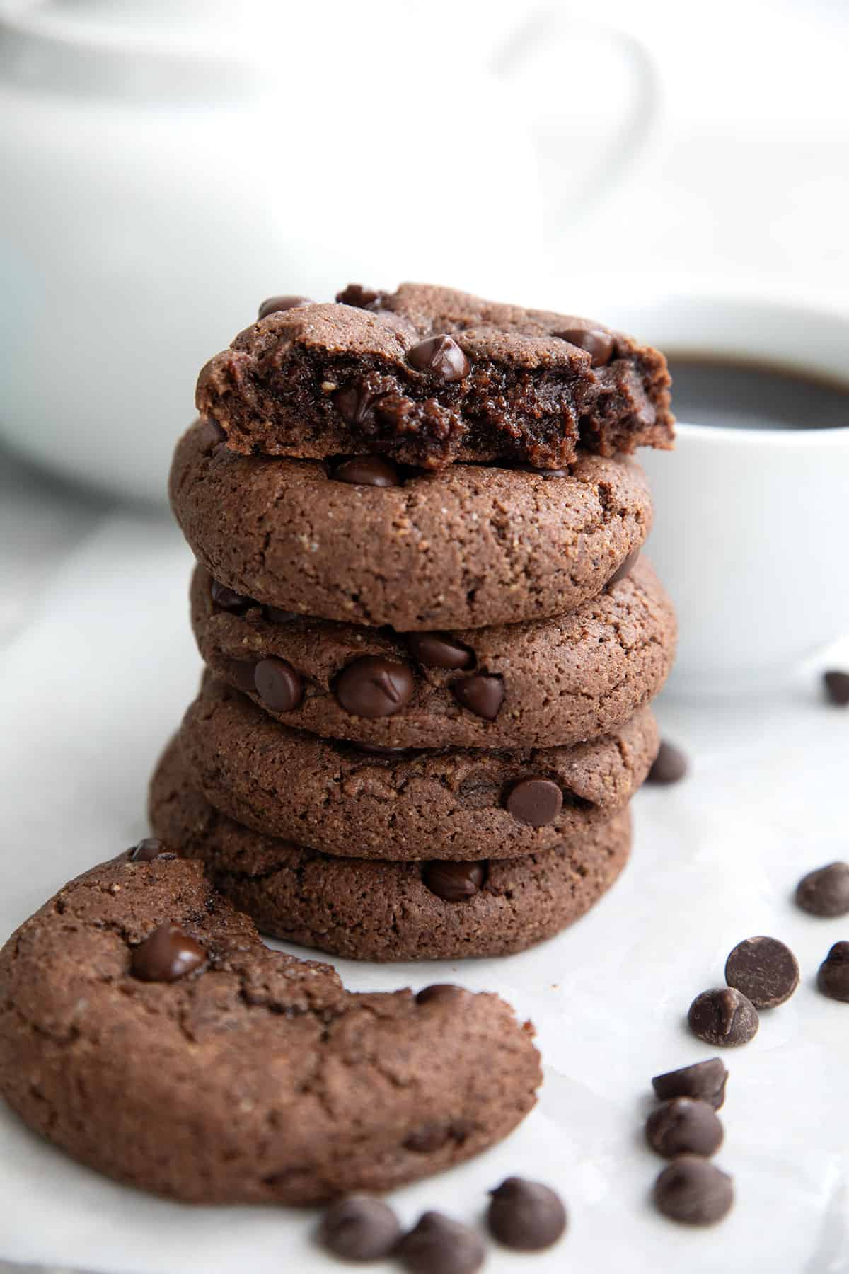 A stack of keto chocolate breakfast cookies with the top one broken open to show the inside.