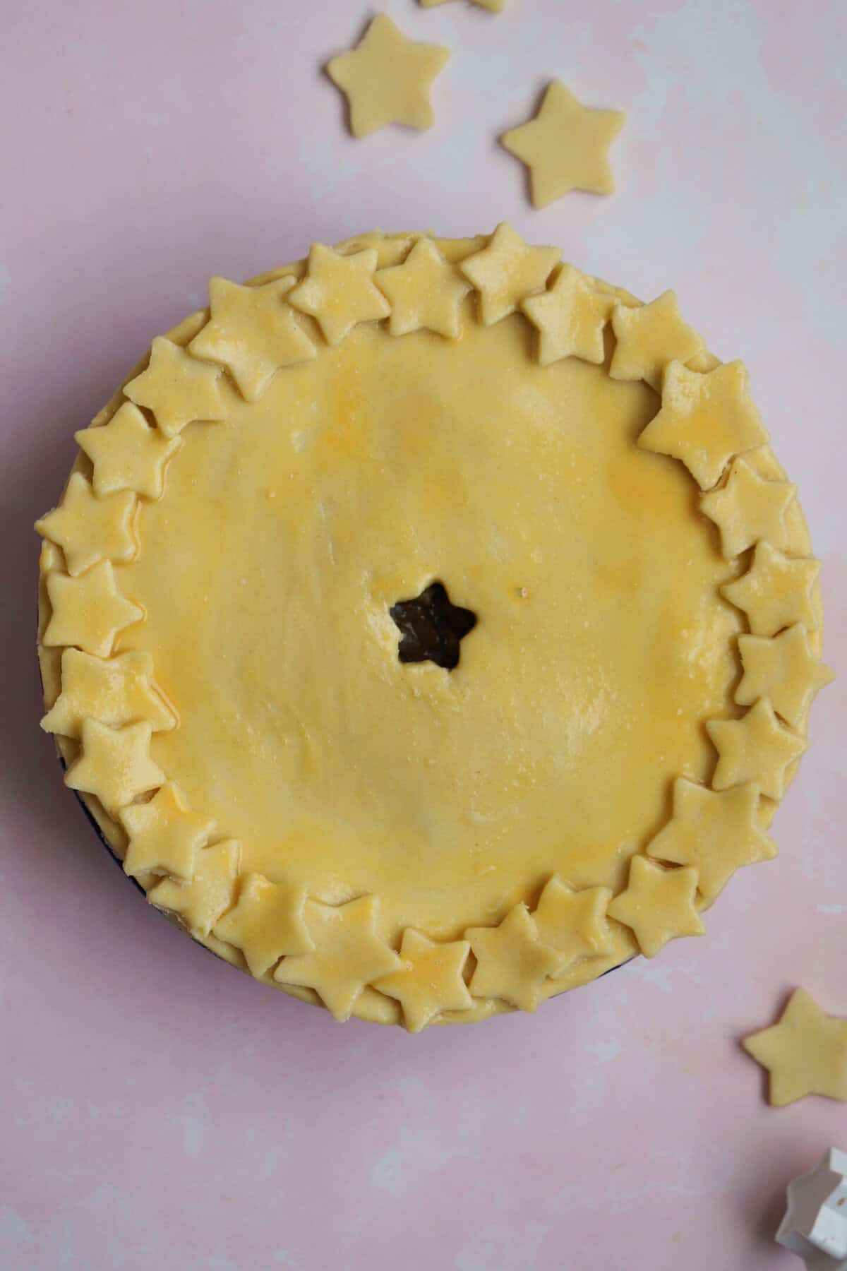 Process shot of a minced beef pie showing the topped pie ready to go into the oven.