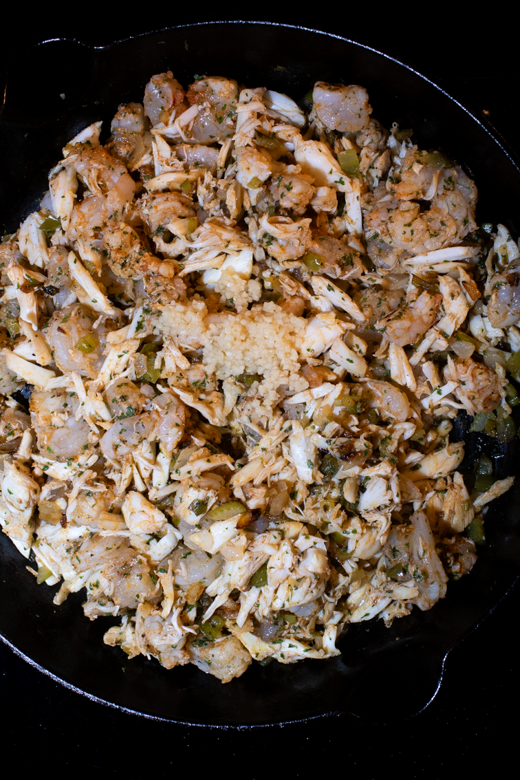 Minced garlic on top of seafood and veggies. 