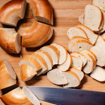 slicing bagels into small pieces for chips.