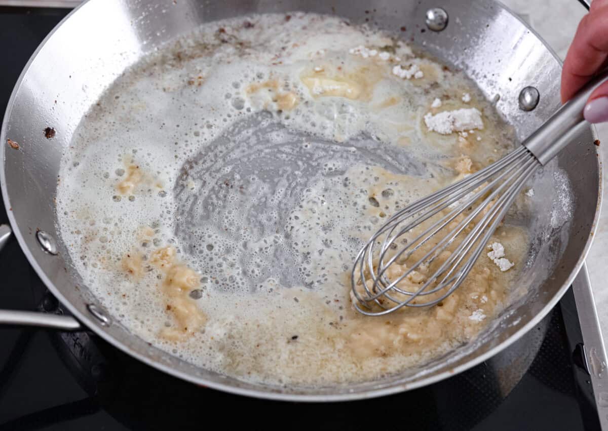 These Swedish Meatballs are smothered in the most amazing rich and creamy gravy and packed with such delicious flavor. You will quickly agree these are the BEST you have ever had! Cooking a roux with butter and flour in a saucepan with a whisk.