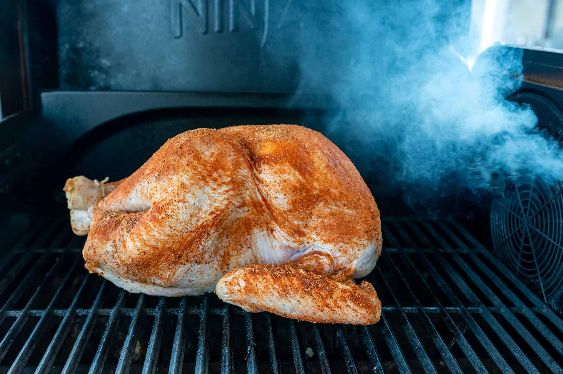 Raw turkey on the ninja flexflame with smoke.