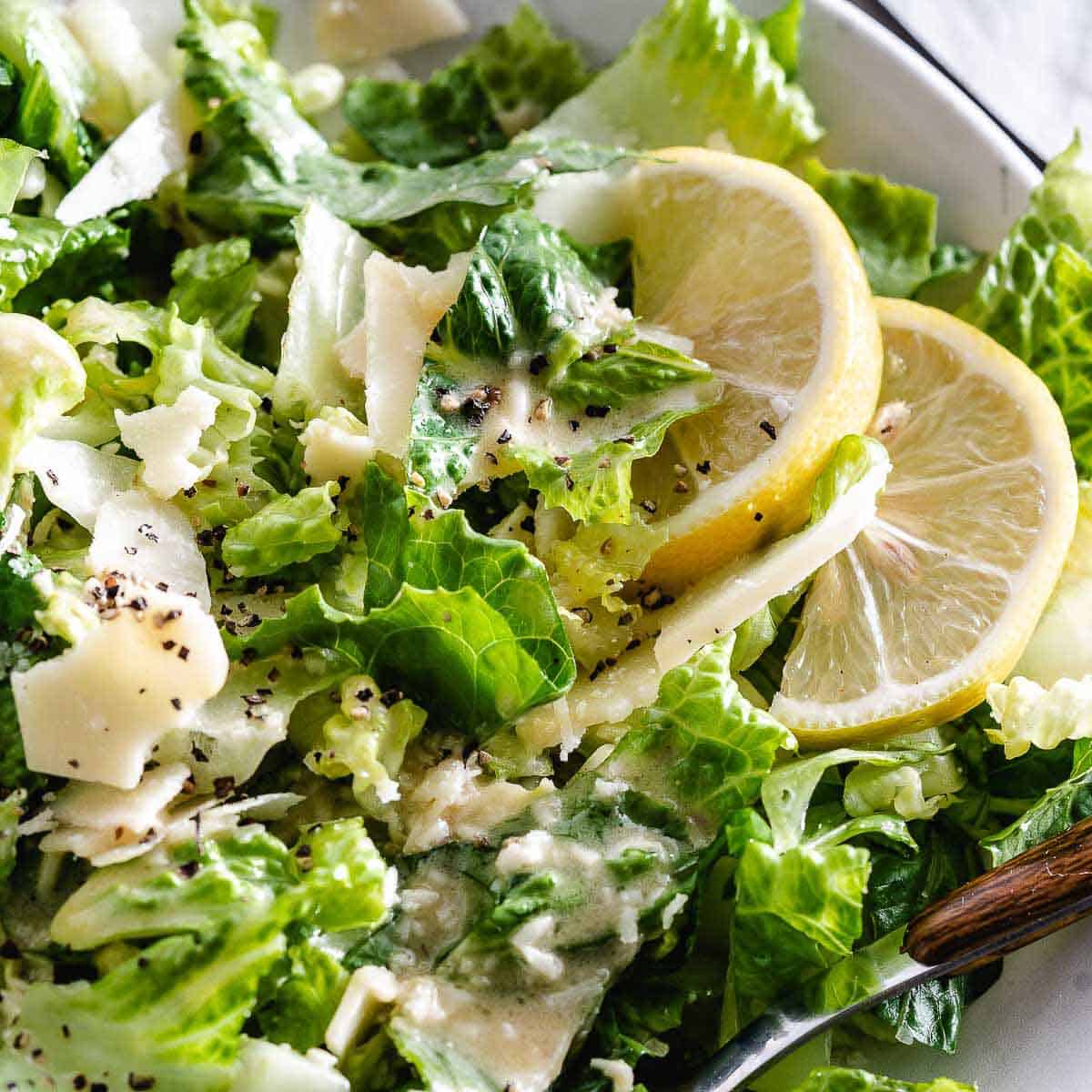 Caesar Salad with spoons in a bowl.