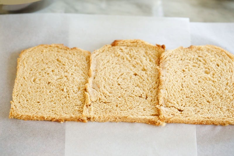 Three bread slices placed closely and joined by brushing with water on the edges.