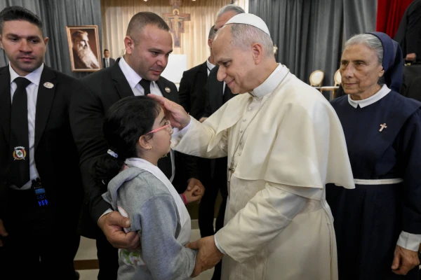 Pope Leo XIV blesses a child at the De La Croix Hospital for the mentally disabled in Jal el Dib, north of Beirut, Lebanon, on Dec. 2, 2025. Credit: Vatican Media