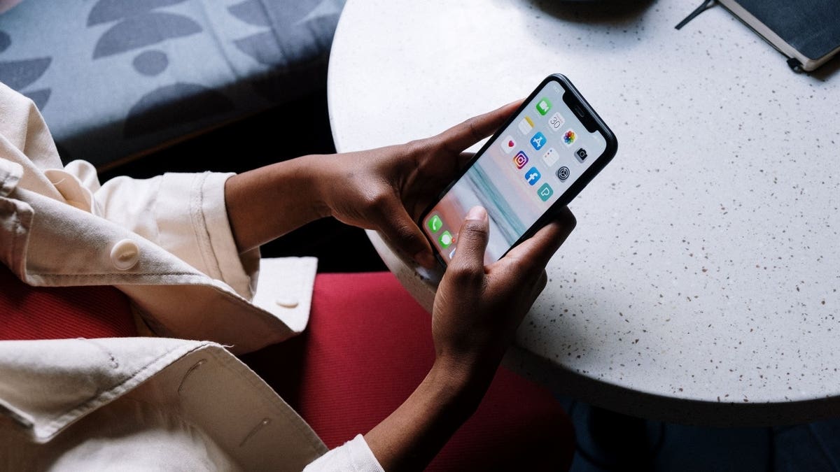 Person typing on a phone.