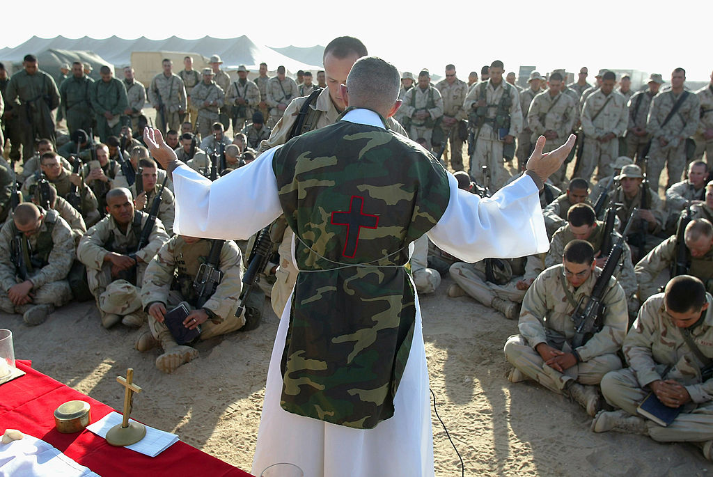 U.S. Marine Chaplain Father Bill Devine offers Mass for Marines from the 1st Marine Division Feb. 23, 2003, in Kuwait. | Credit: Robert Nickelsberg/Getty Images