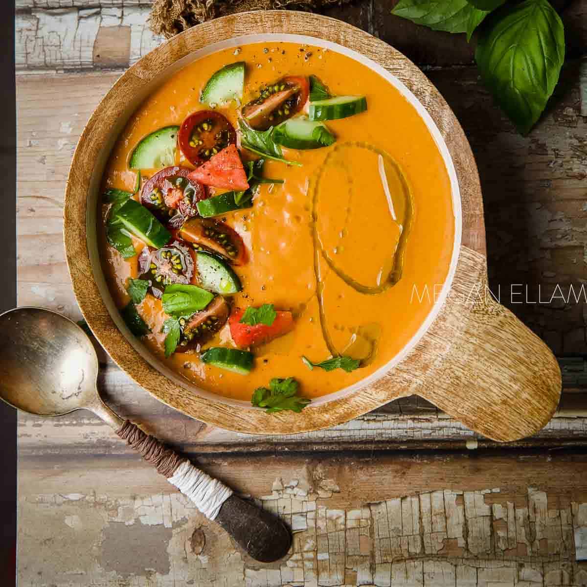 Gazpacho in a wood bowl with salsa on top.