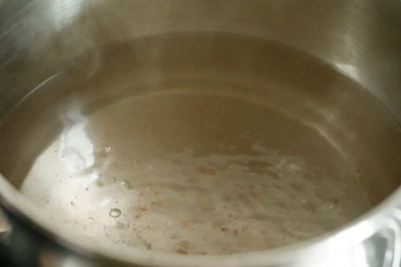 Water seasoned with salt boiling in a pan.