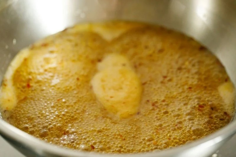 Bubbling mixture in pan.