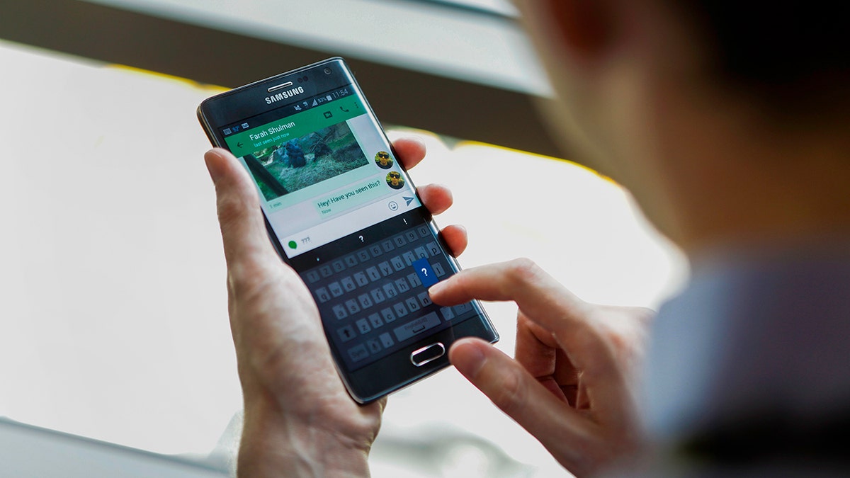 Person typing on a Samsung phone.