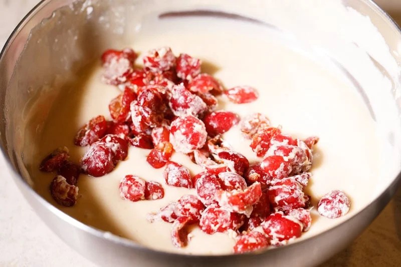 Flour coated cherries on top of cake batter.