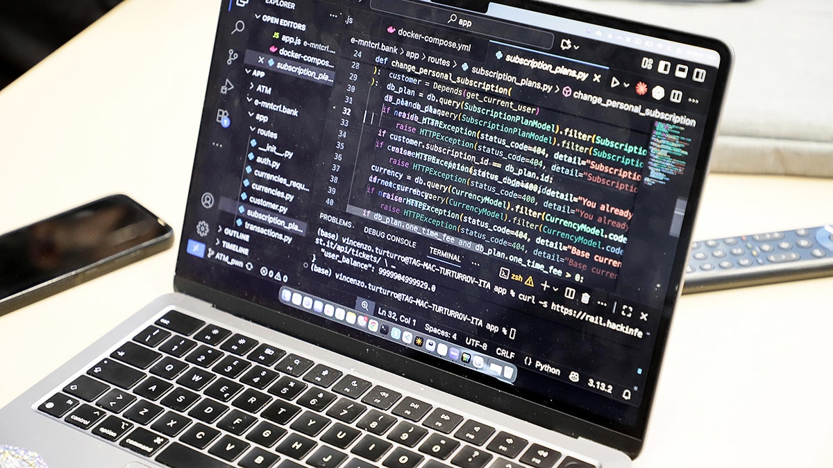 Laptop open to code on the screen.