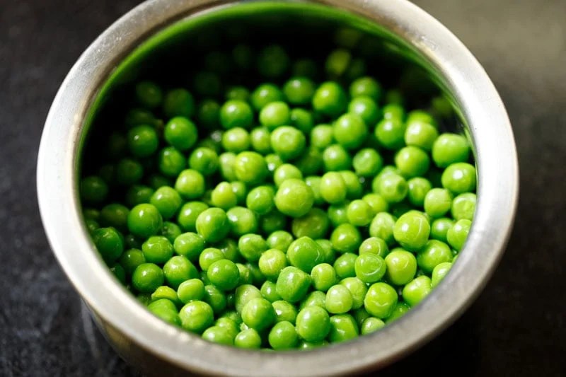 Rinsed fresh green peas or matar in a bowl.