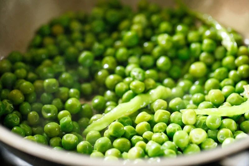 Mix of green chillies and green peas.
