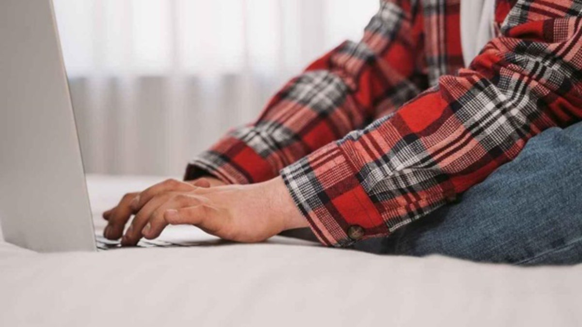 sitting at laptop