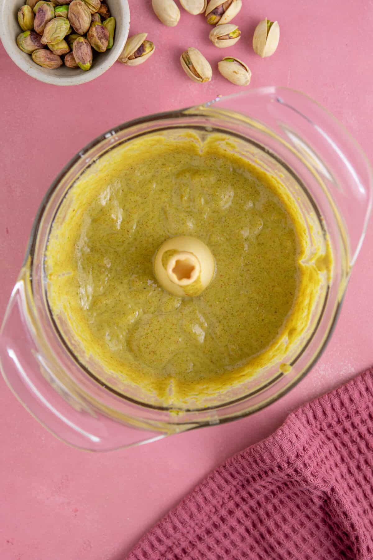 Process shot for pistachio spread recipe showing the finished paste in a food processor.