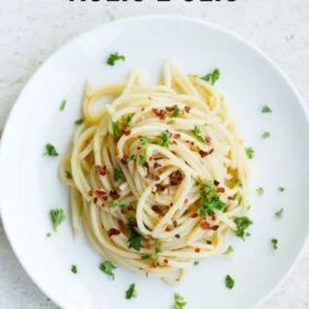 Plate of spaghetti aglio e olio​with herbs.