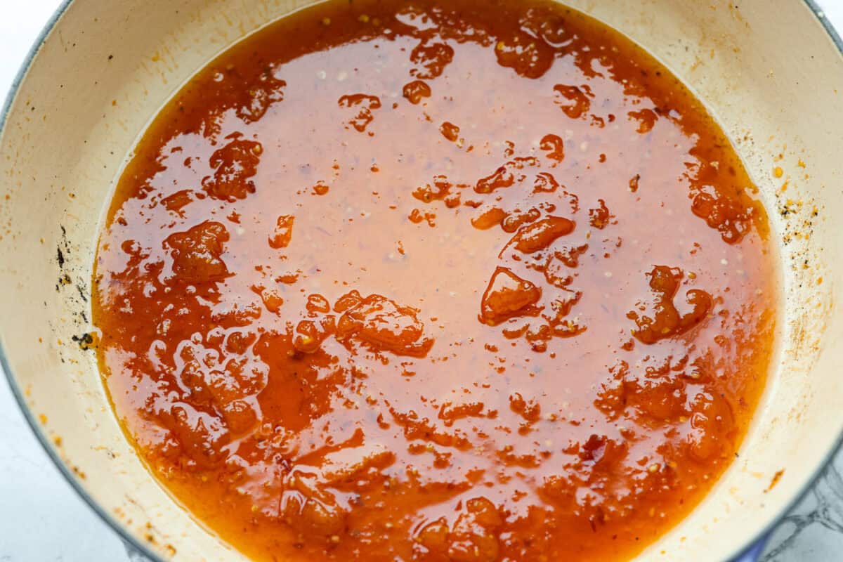 Sauce ingredients cooking and thickening in the skillet. 