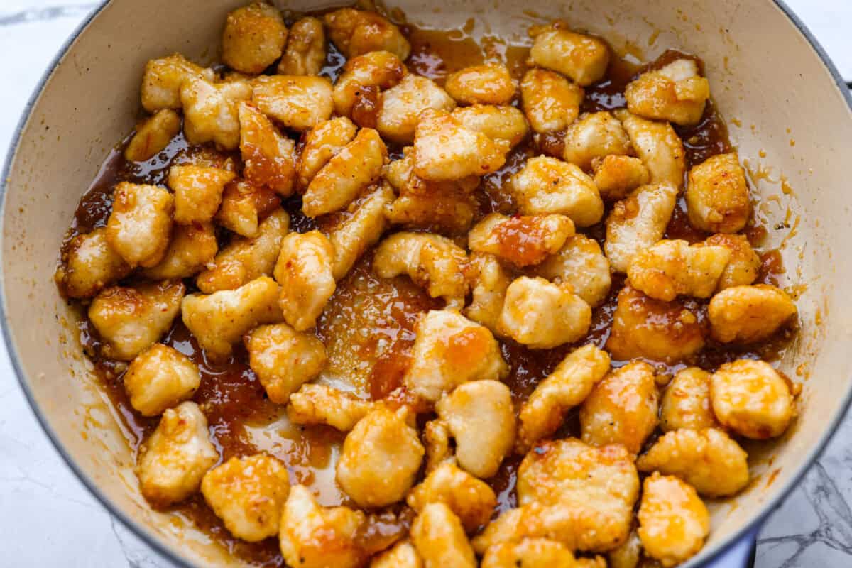 Chicken pieces added to the skillet with the apricot sauce. 