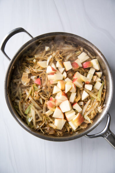 braised cabbage and apples in skillet