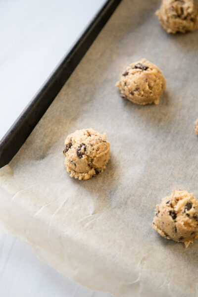 scoops of coconut flour chocolate chip cookie dough on a sheet pan