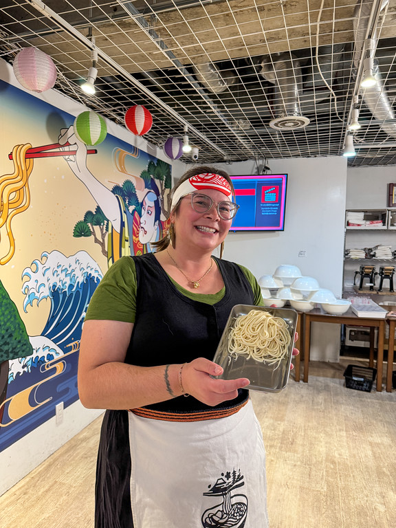 Amanda with noodles in a ramen cooking class