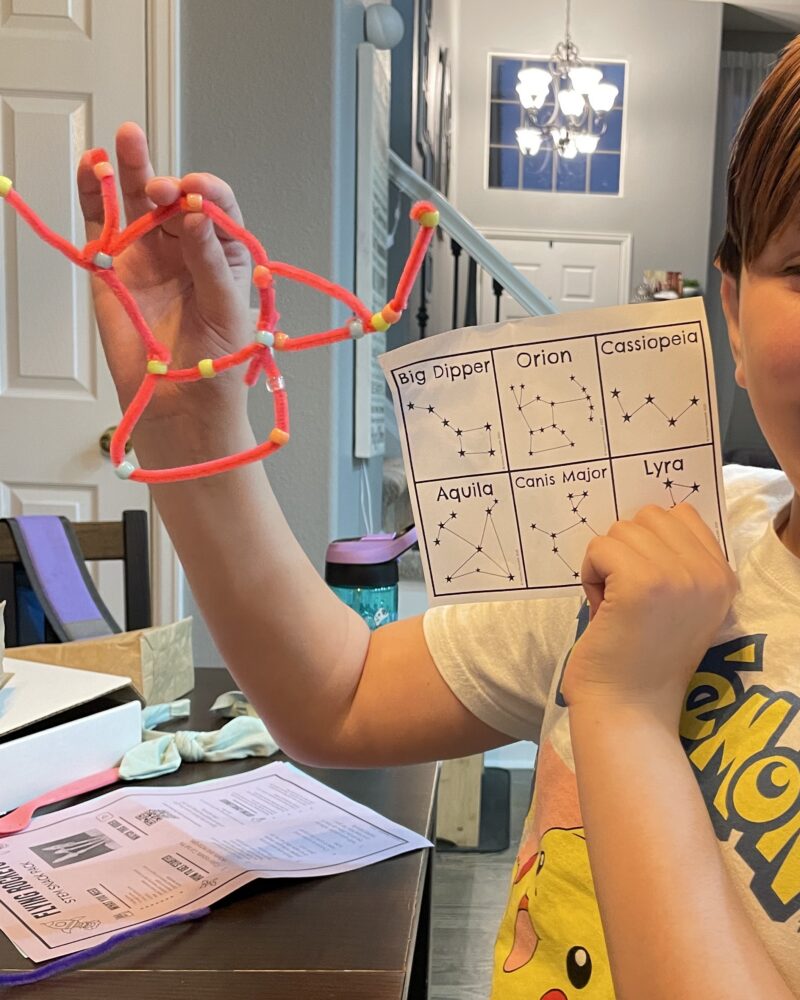 an image of a student making a constellation out of pipe cleaners and beads