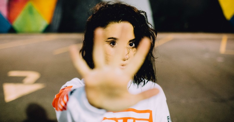 woman saying no with hand toward camera