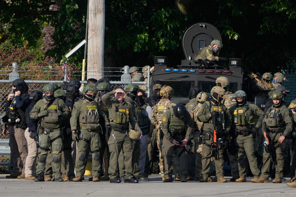 Greg Bovino, the chief patrol agent for the U.S. Border Patrol El Centro sector, center, stands with federal immigration agents near an Immigration and Customs Enforcement facility in Broadview, Ill., Oct. 3, 2025. (AP Photo/Erin Hooley, File)