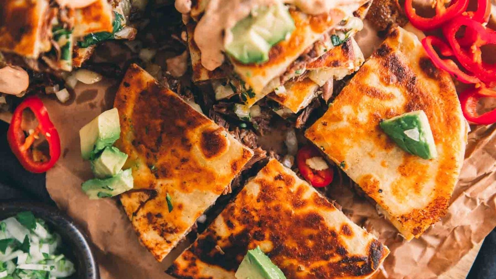 Birria quesadilla stuffed with melted cheese and shredded birria folded with crispy edges.