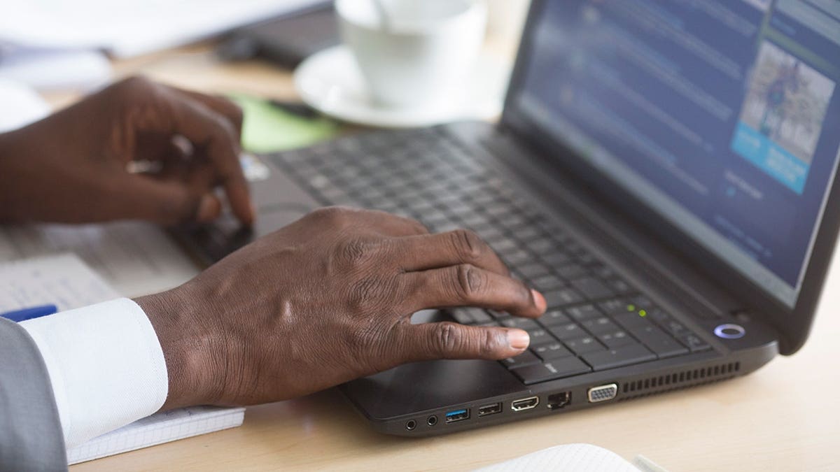 Man typing on his computer.