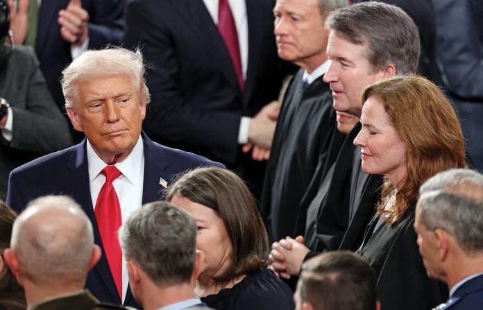 Arriving at the House of Representatives Chamber for a State of the Union address, President Donald Trump passes Amy Coney Barrett (second from right), along with Chief Justice John Roberts (at top) and Associate Justice Brett Kavanaugh (third from right), Feb. 24, 2026.  (Win McNamee/Getty)
