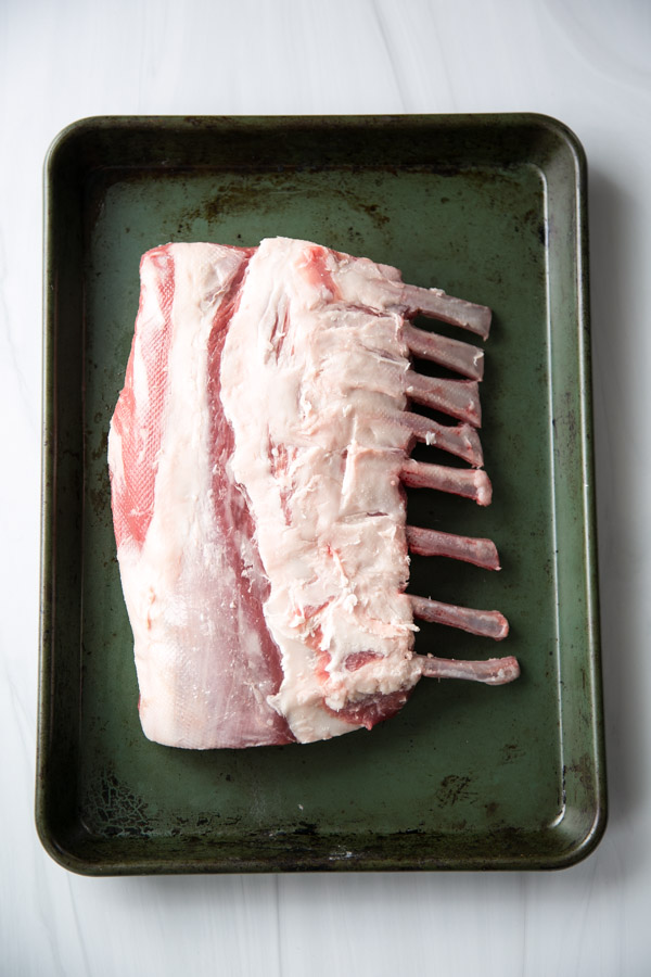 whole rack of lamb on a sheet pan