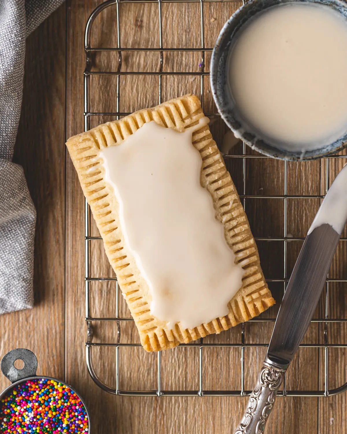 A strawberry pop tart frosted with vanilla icing.
