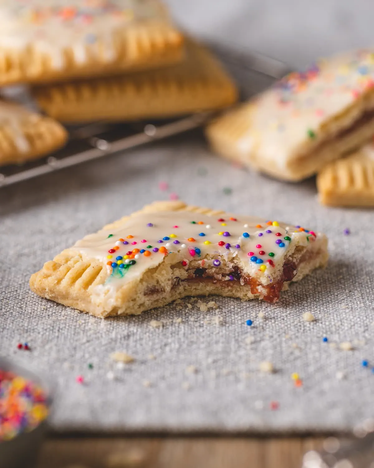 A bite missing from a strawberry pop tart.