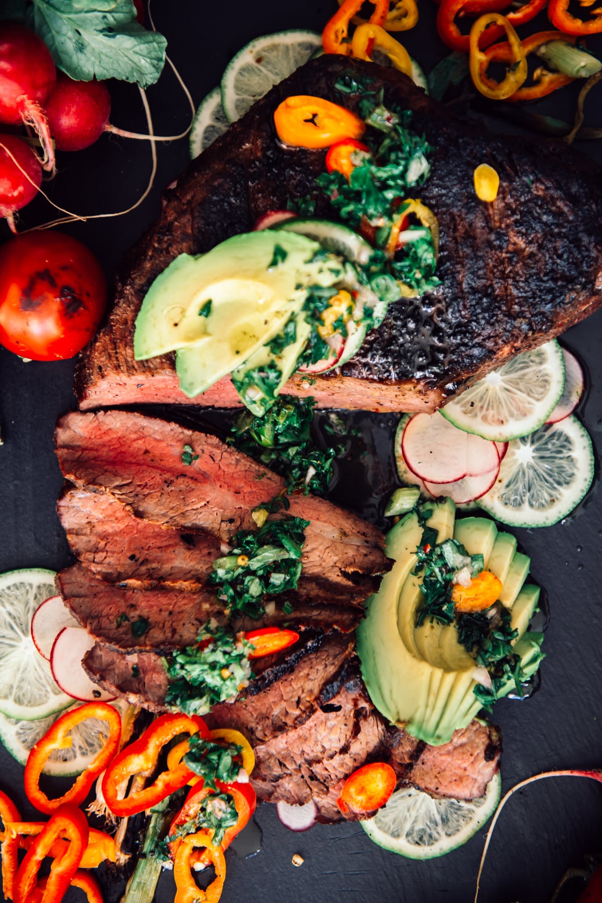 sliced tri tip with avocado, chimichurri and peppers
