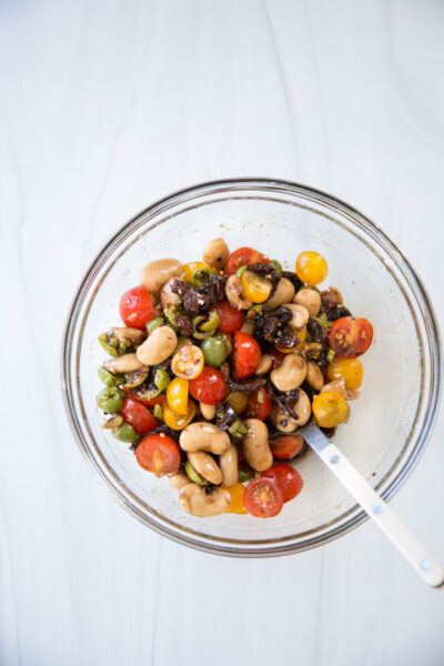 tomatoes olives sundried tomatoes beans marinating in a bowl