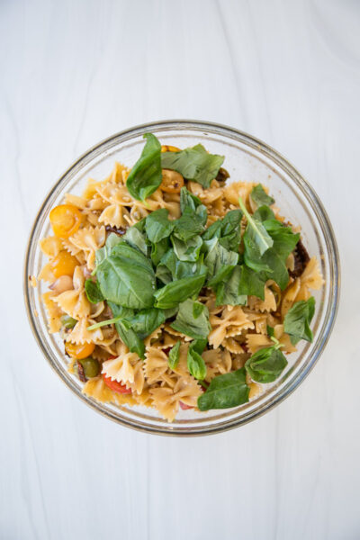 gluten-free pasta salad with basil garnish in a bowl