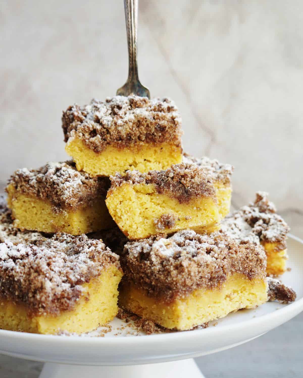 stack of keto coffee cake squares on a cake platter