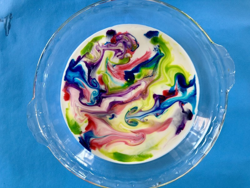 Glass bowl with rainbow milk.