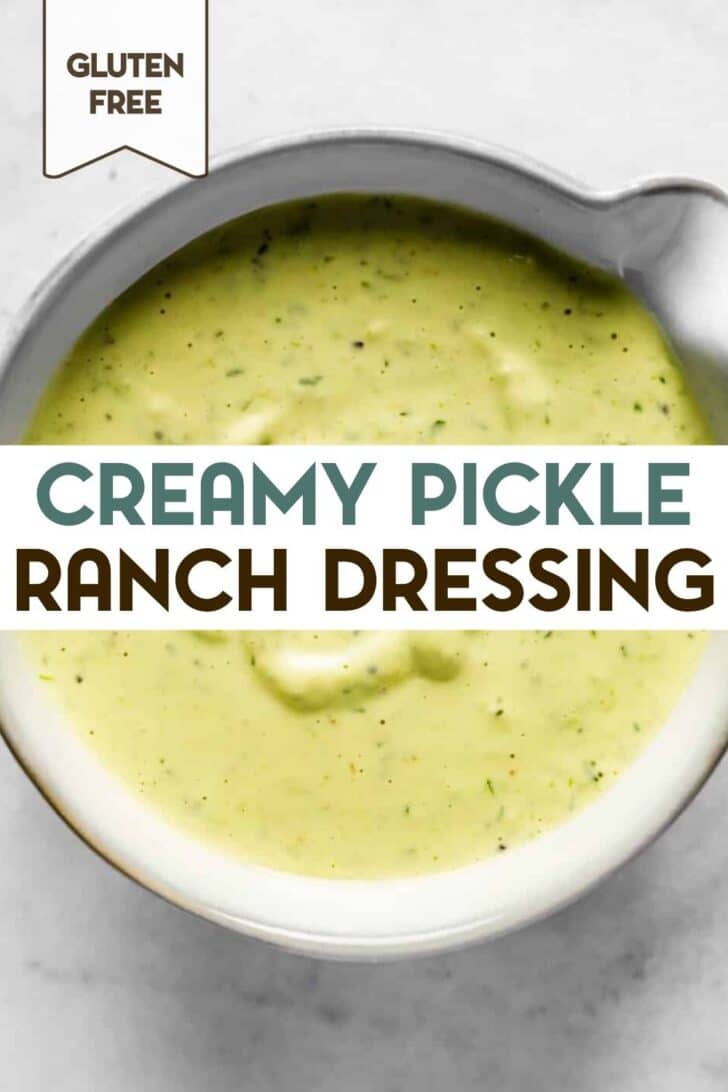 Close-up of creamy pickle dressing in a bowl with a text overlay for pinterest.