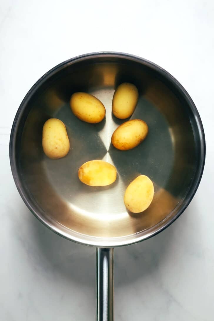A sauce pan with new potatoes