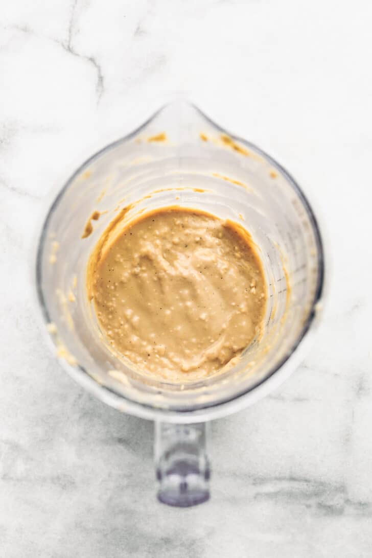 Thick pancake batter blended in a small blender cup with visible oat texture.