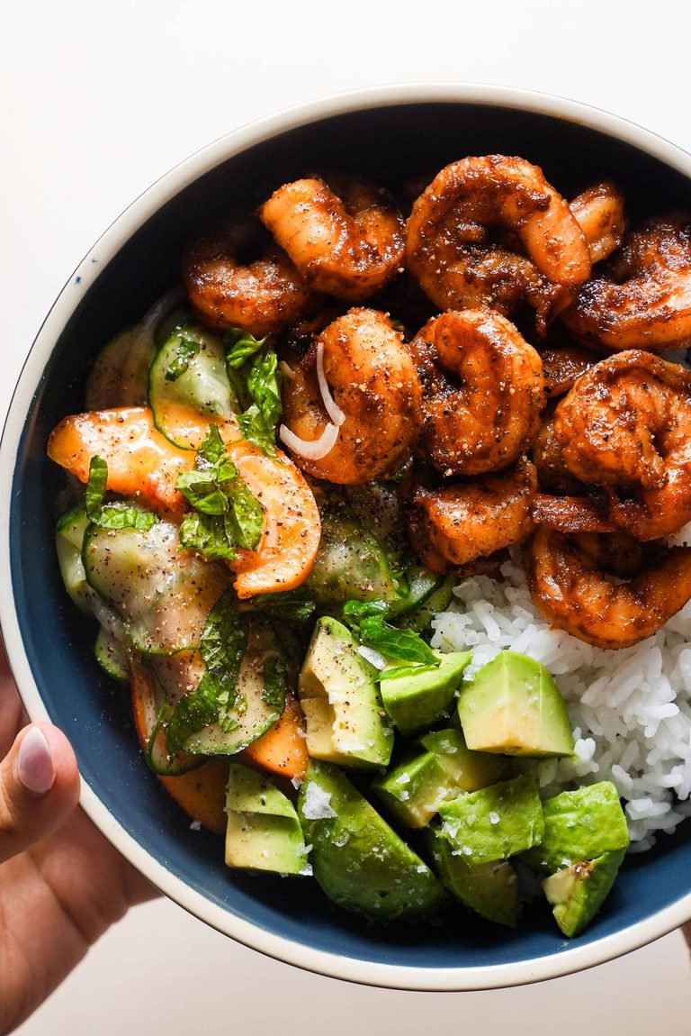 Spicy shrimp in a bowl with rice and peach salad.