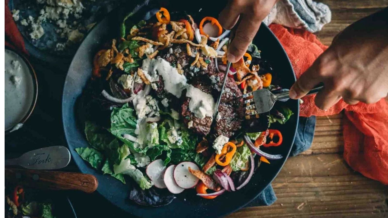 Hamburger salad topped with seared beef and keto blue cheese dressing.